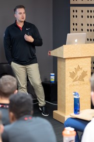 Joshua Hoetmer speaking at a podium